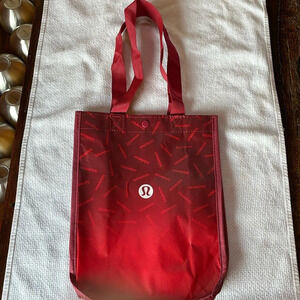 LULULEMON RED REUSABLE SMALL TOTE. Ombré w/ lululemon hits scattered all over